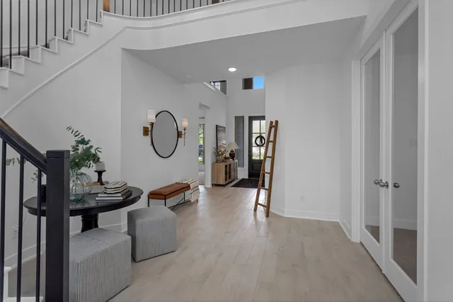 a living room with furniture a chandelier and a potted plant