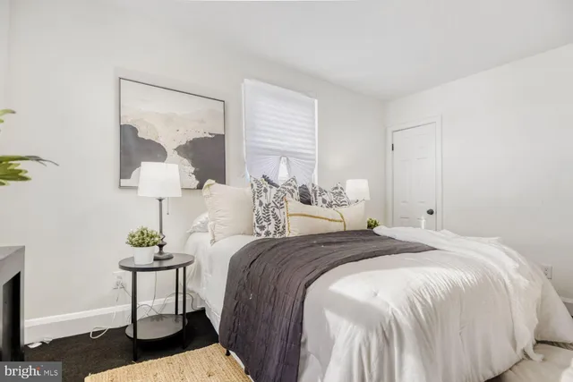 a bedroom with a bed and a table