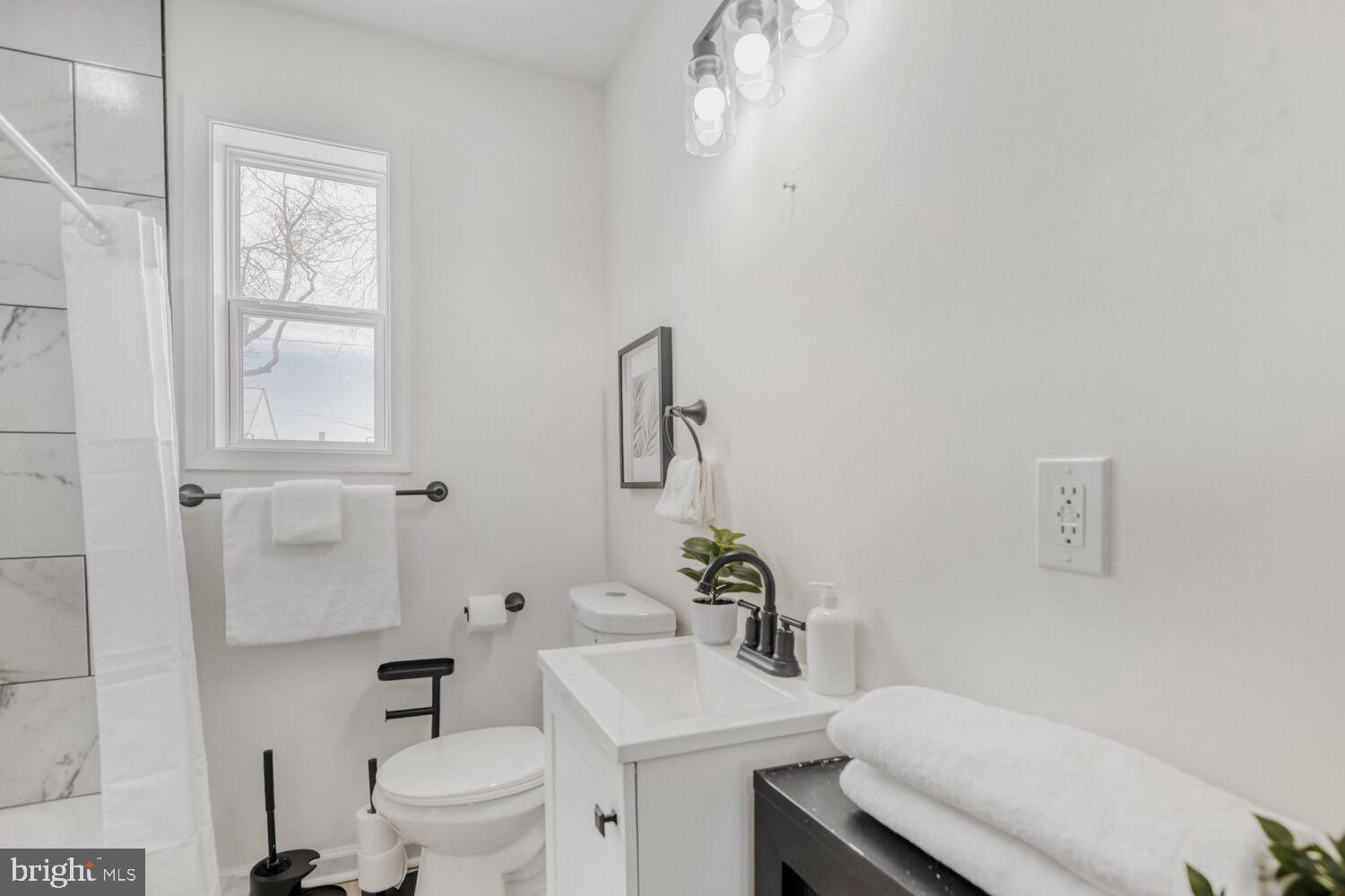 100 Shipway Dundalk, MD 21222 - Photo 18 of 28 a bathroom with a sink toilet and a mirror