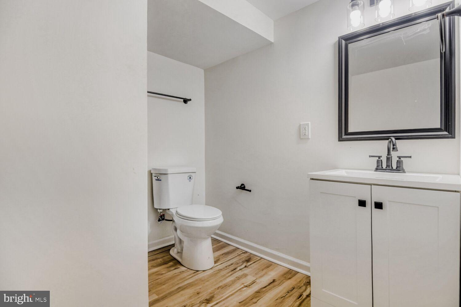 100 Shipway Dundalk, MD 21222 - Photo 24 of 28 a bathroom with a toilet a sink and mirror