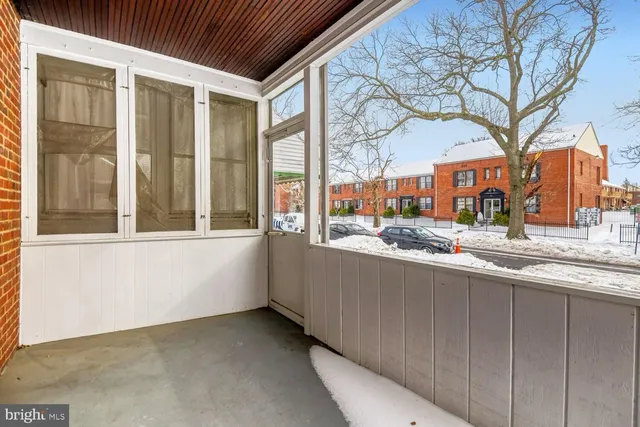 a kitchen with large windows and a large tree