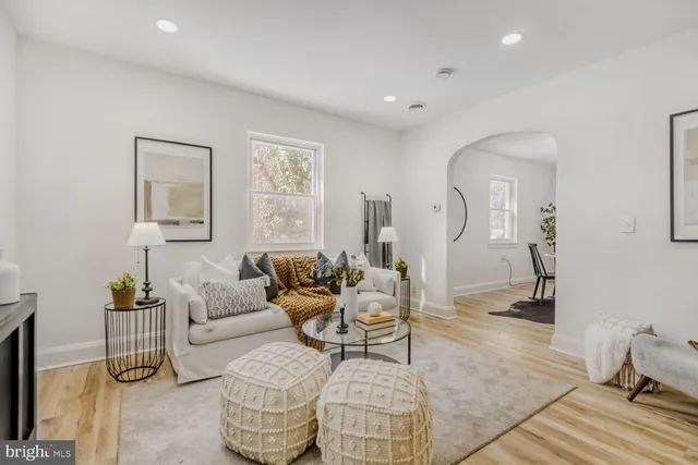 a living room with furniture rug and a window