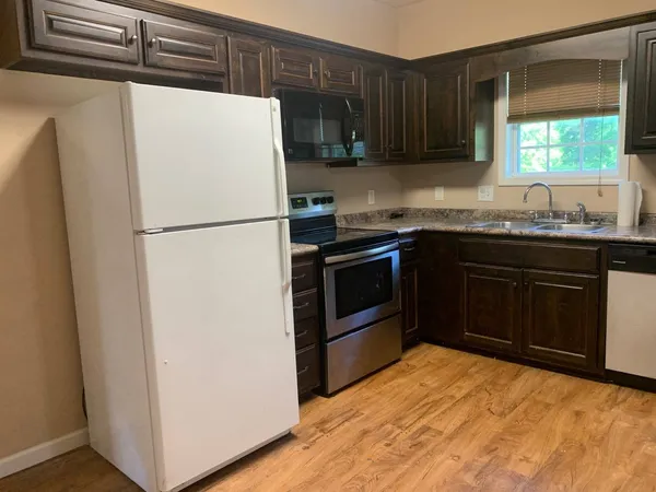 a white refrigerator freezer sitting inside of a kitchen