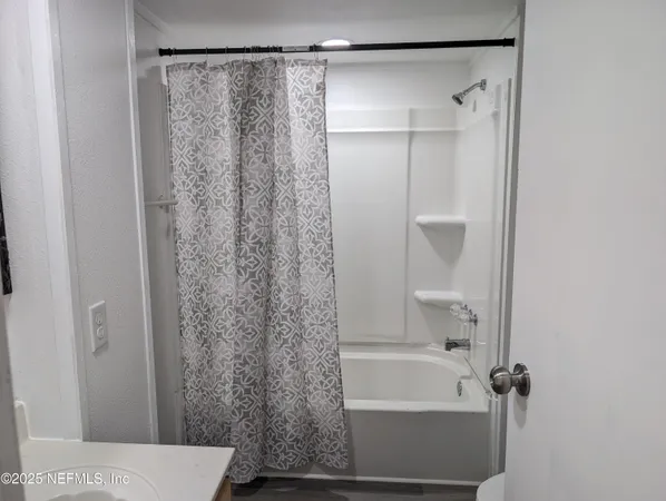 a bathroom with a shower and a bath tub