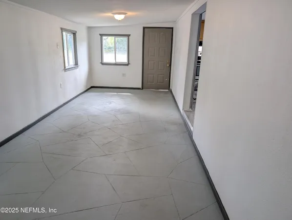 a view of an empty room with windows