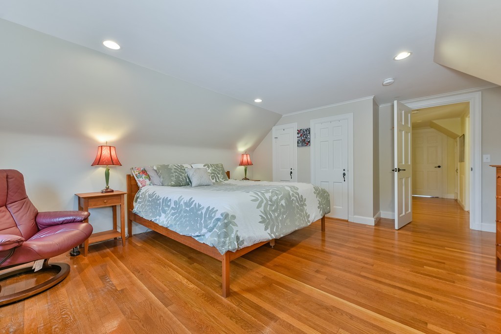 74 Puritan Road Newton, MA 02468 - Photo 16 of 25 a bedroom with a bed and wooden floor