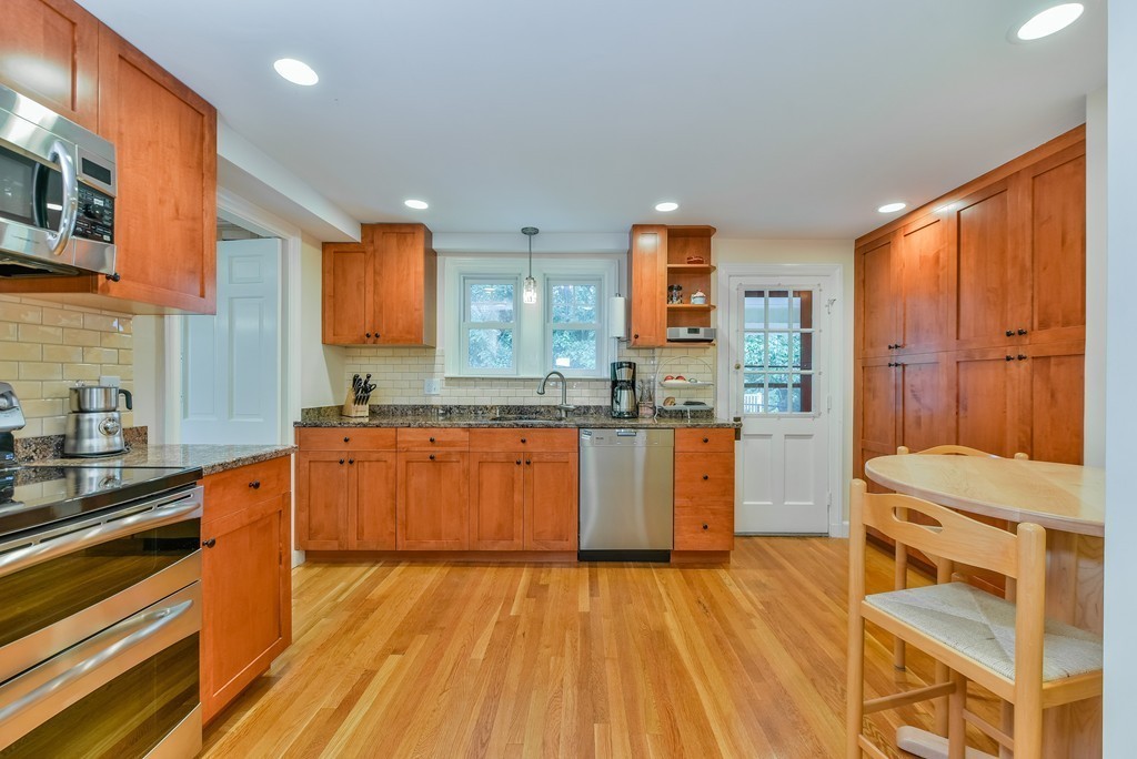 74 Puritan Road Newton, MA 02468 - Photo 10 of 25 a kitchen with stainless steel appliances granite countertop a stove a sink dishwasher and a refrigerator with wooden floor