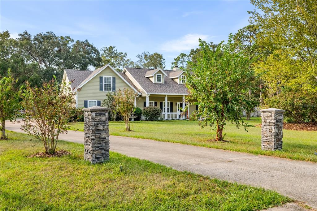 16446 Northwest 208th Way High Springs, FL 32643 - Photo 1 of 1 a front view of a house with a yard and trees