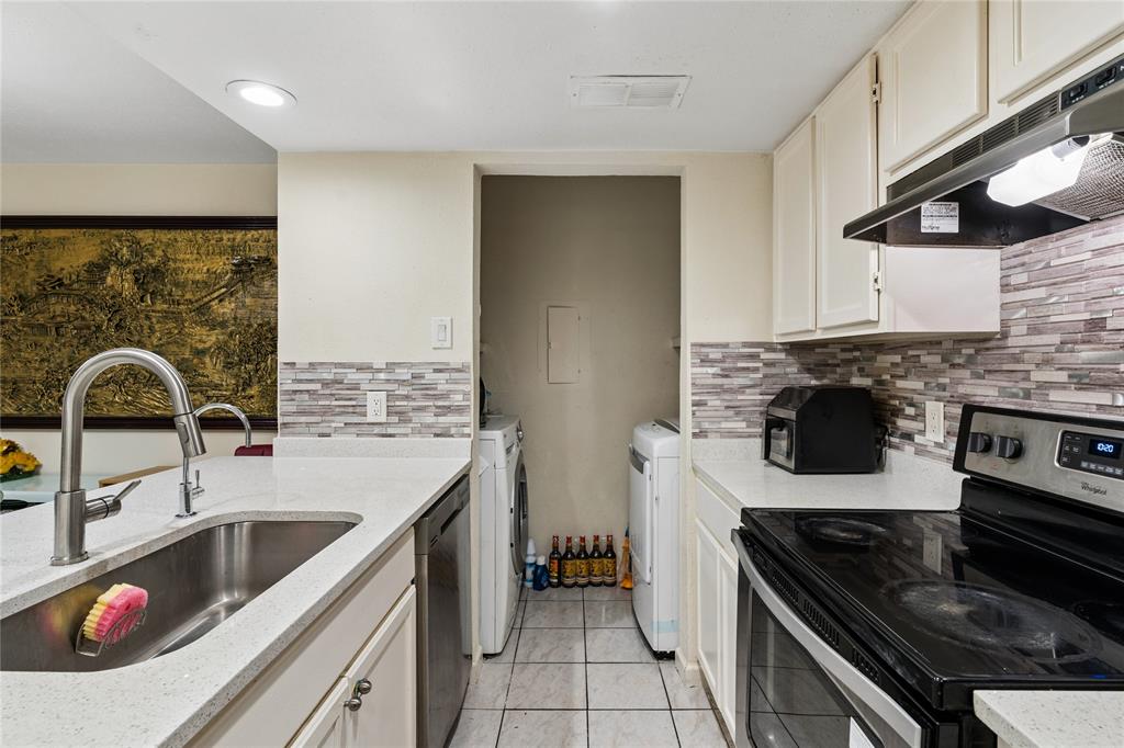 11311 Audelia Road, Unit 102 Dallas, TX 75243 - Photo 9 of 31 Kitchen featuring light countertops, white cabinetry, integrated stainless steel sink, and a tiled backsplash