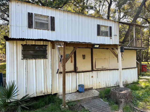 a view of a house with backyard space and wooden fence