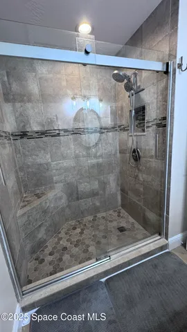a bathroom with a glass shower door