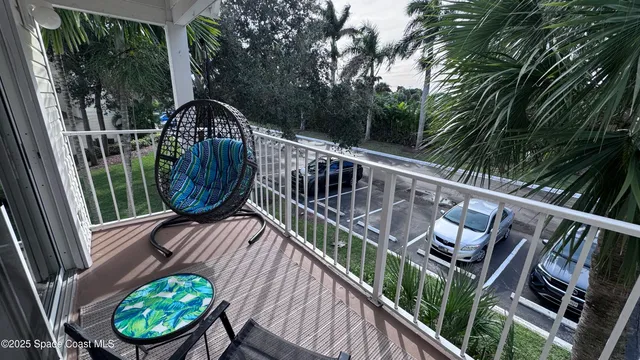 a view of balcony with wooden floor and outdoor seating