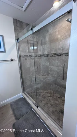 a bathroom with a glass shower door