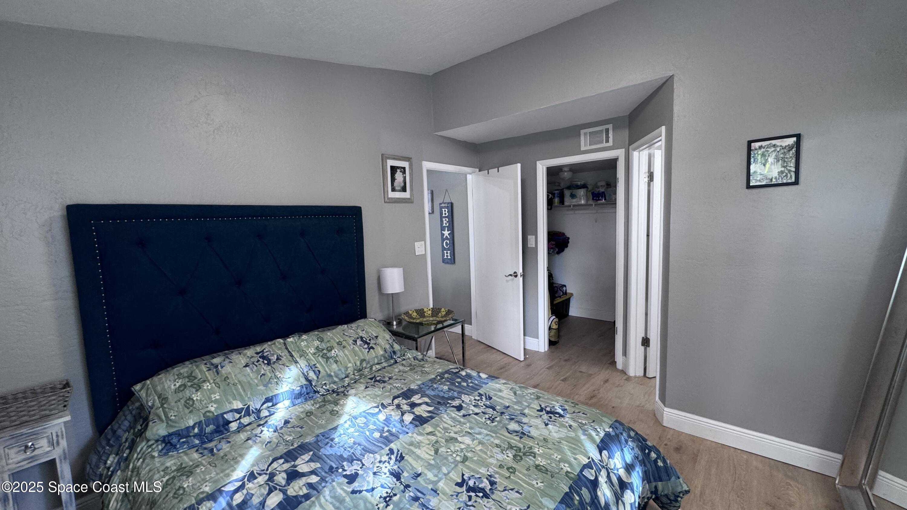 1841 Island Club Drive, Unit 472 Indialantic, FL 32903 - Photo 19 of 23 a bedroom with a bed and a dresser