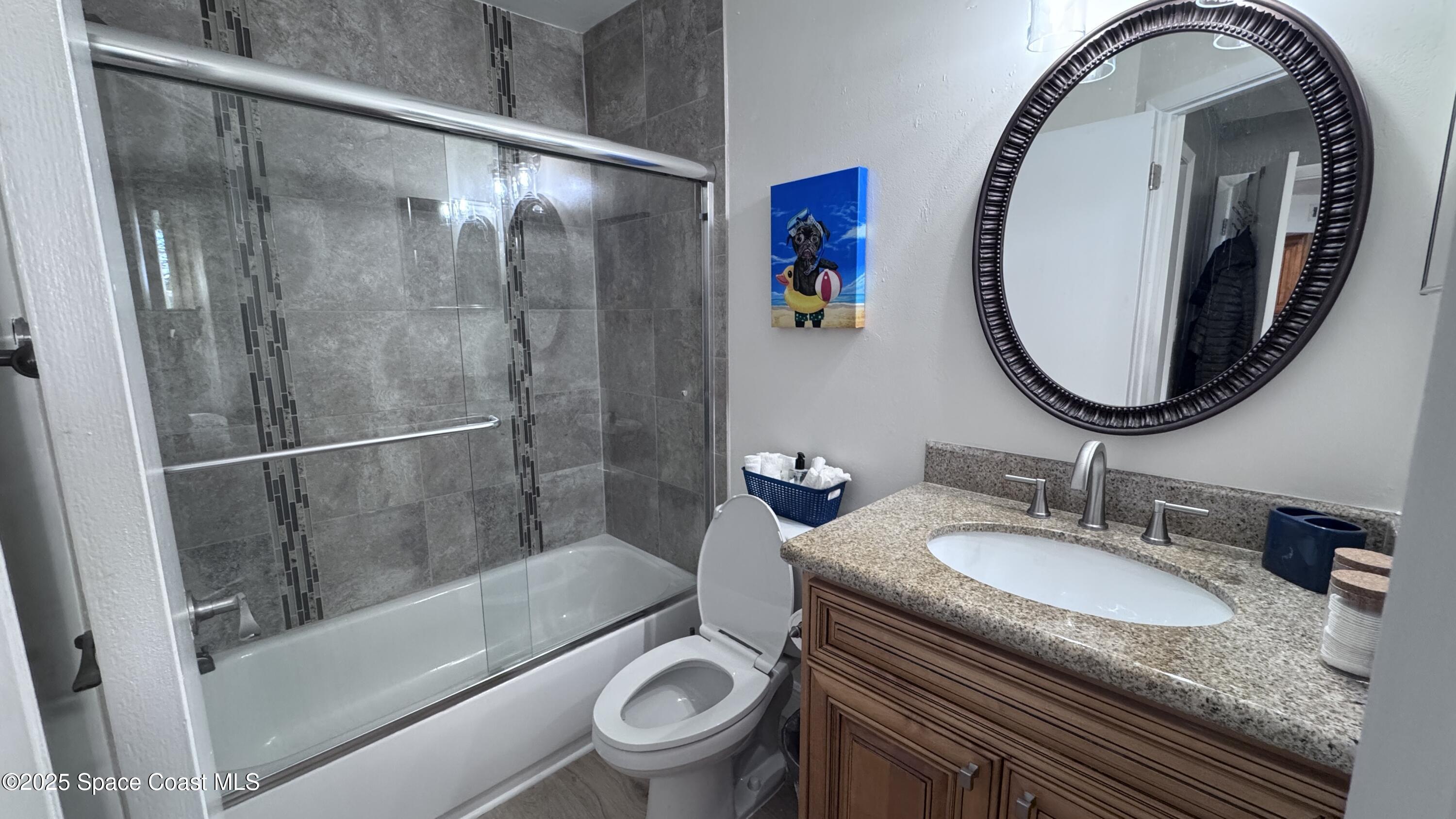 1841 Island Club Drive, Unit 472 Indialantic, FL 32903 - Photo 20 of 23 a bathroom with a granite countertop sink toilet and shower