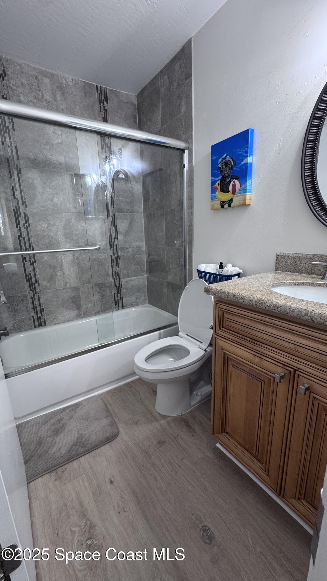 1841 Island Club Drive, Unit 472 Indialantic, FL 32903 - Photo 21 of 23 a bathroom with a granite countertop sink a toilet and a shower