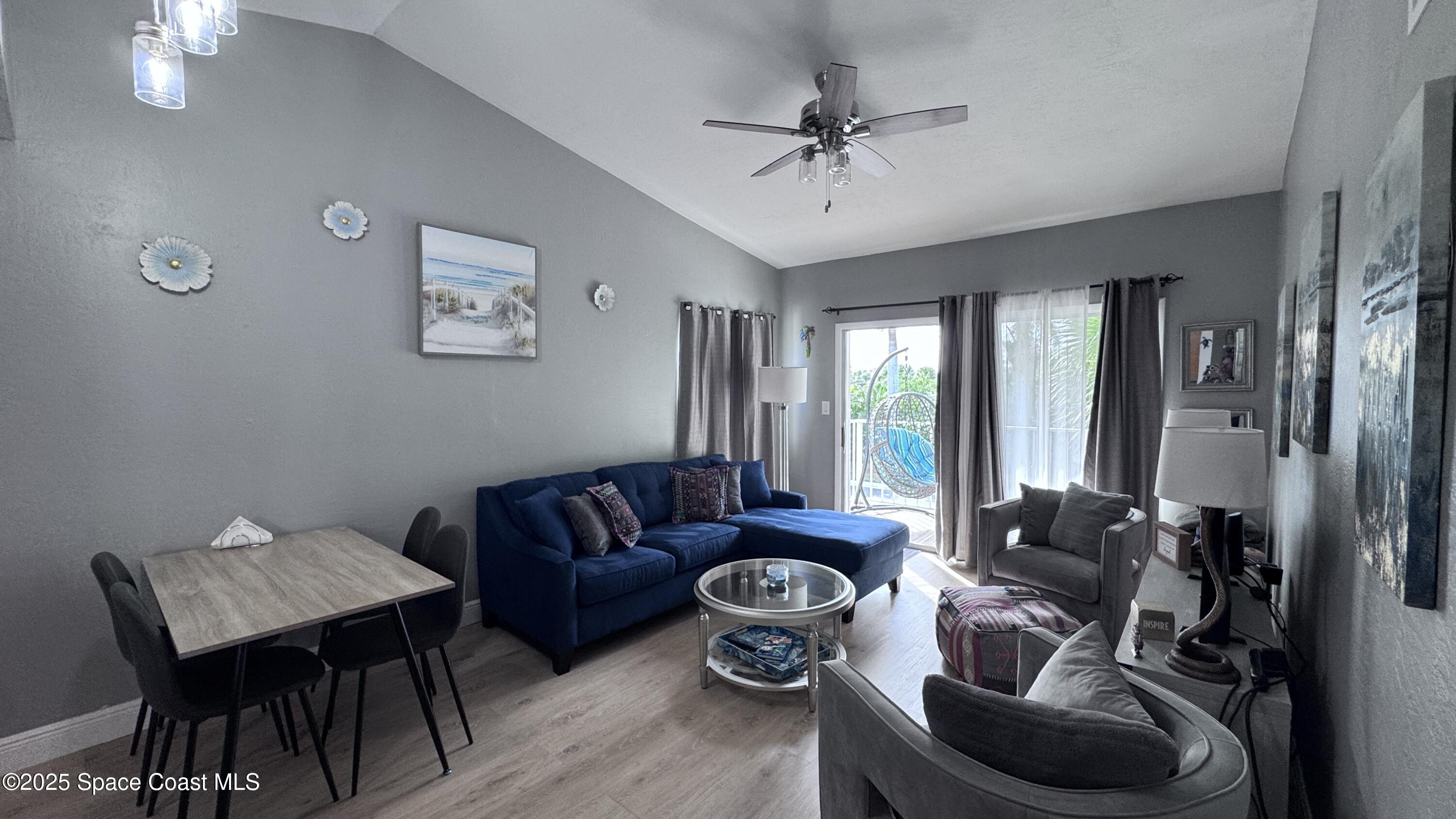 1841 Island Club Drive, Unit 472 Indialantic, FL 32903 - Photo 5 of 23 a living room with furniture and a large window