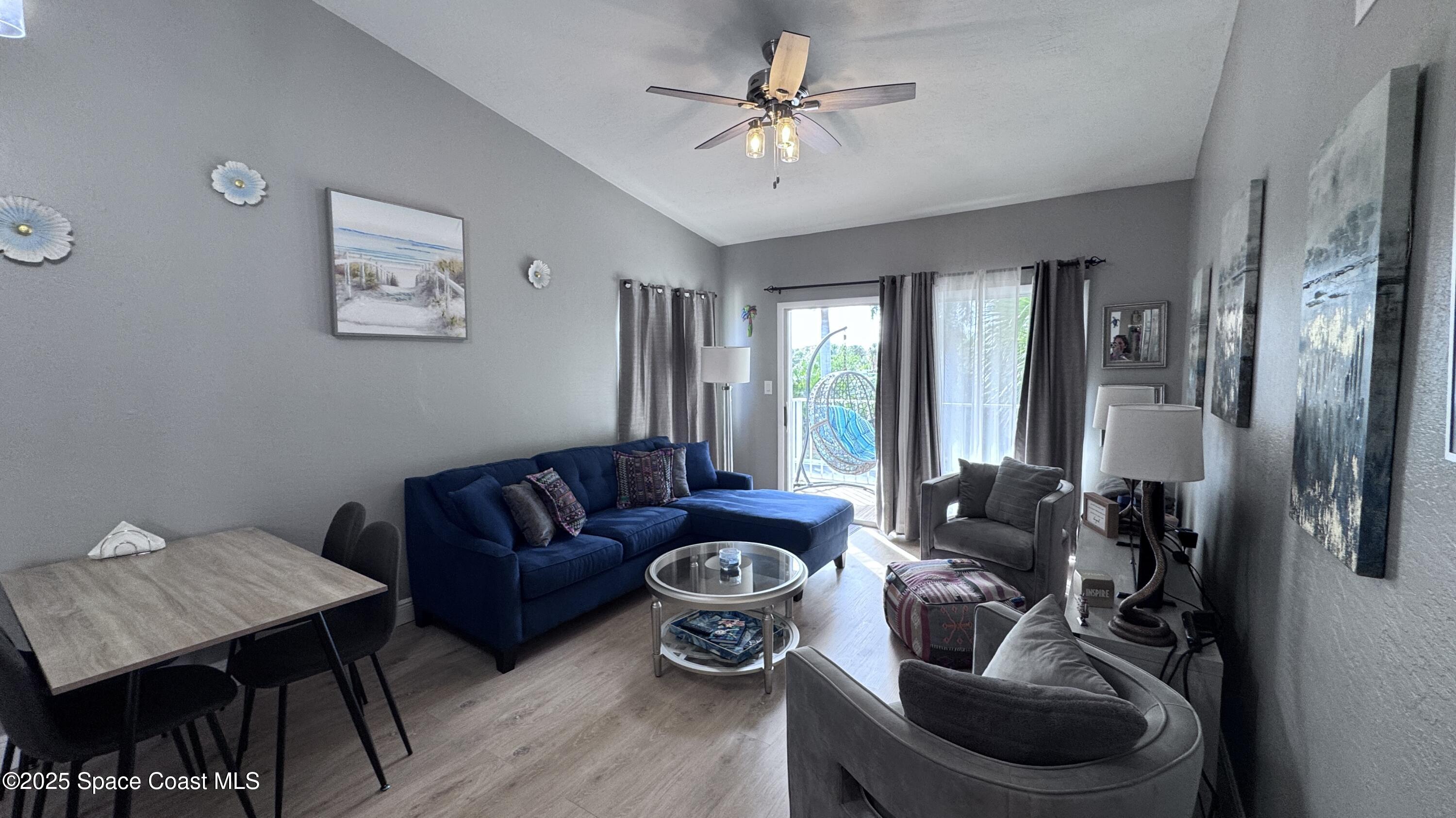 1841 Island Club Drive, Unit 472 Indialantic, FL 32903 - Photo 6 of 23 a living room with furniture and a chandelier