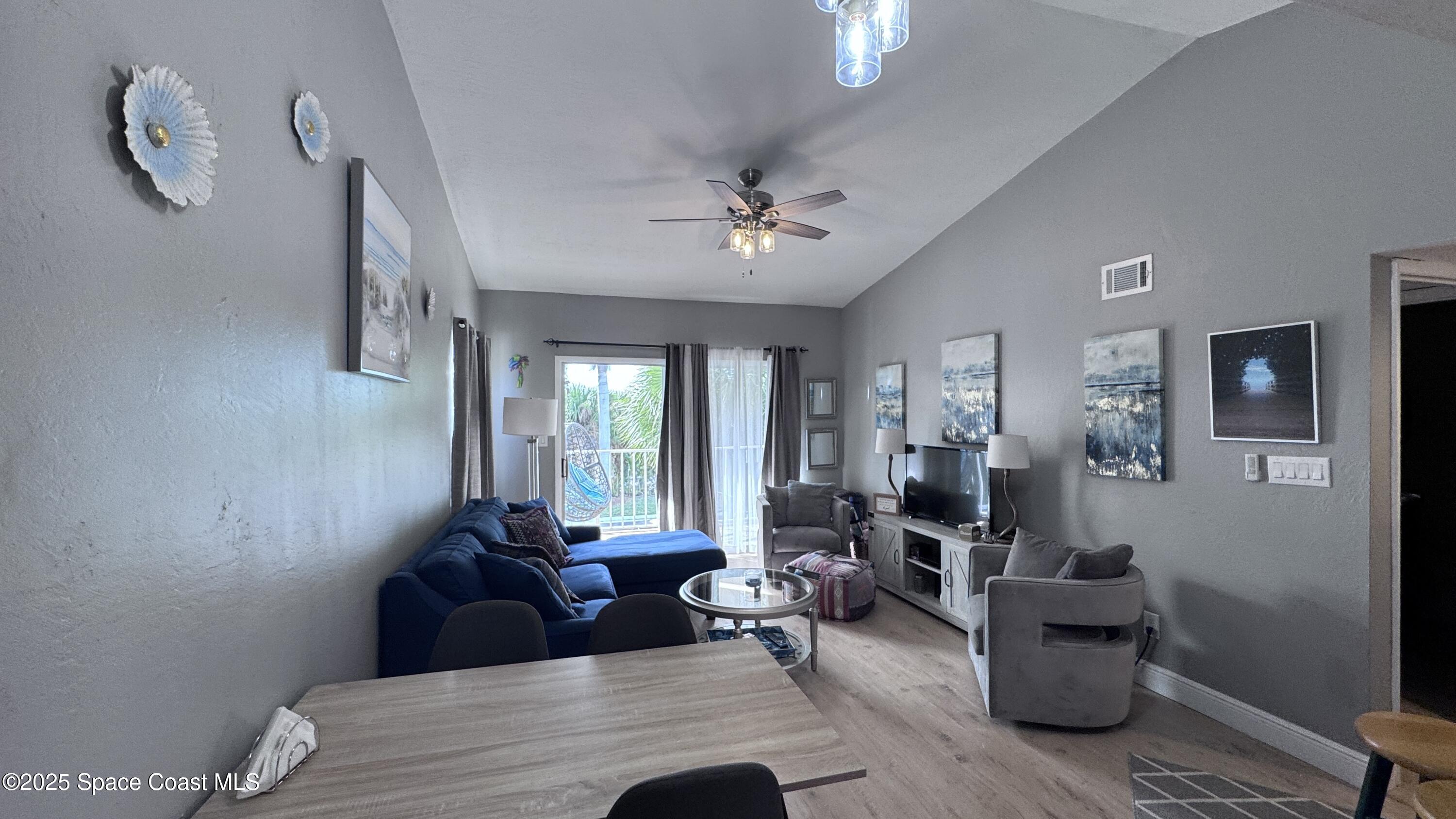 1841 Island Club Drive, Unit 472 Indialantic, FL 32903 - Photo 7 of 23 a living room with furniture and wooden floor