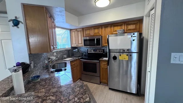 a kitchen with a refrigerator and a sink