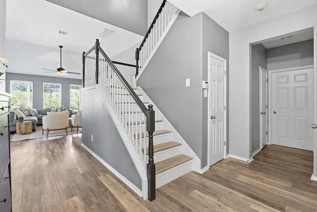 a view of entryway and hall with wooden floor