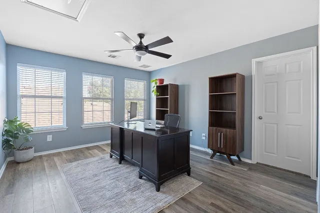a living room with furniture windows and wooden floor