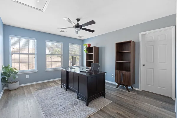 a living room with furniture windows and wooden floor