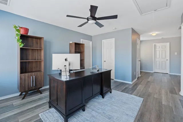 a view of workspace with wooden floor shelves