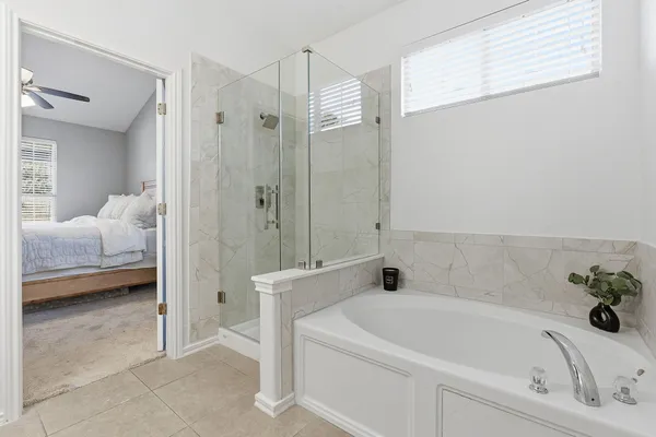 a bathroom with a tub a sink and a shower