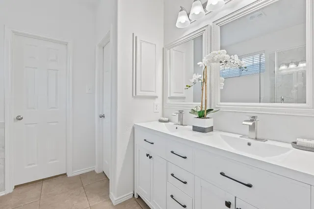 a bathroom with a double vanity sink mirror and