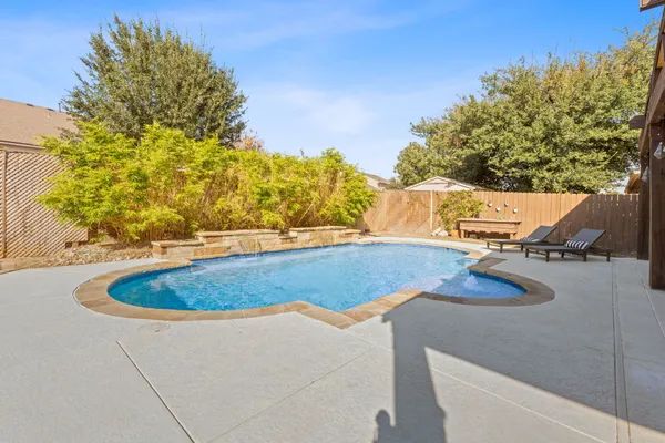 a view of a house with swimming pool and sitting area