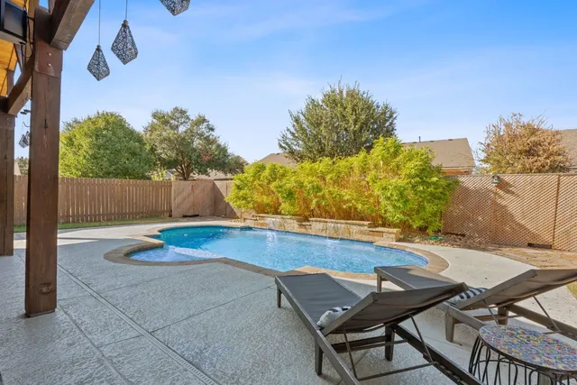 a view of a backyard with plants and sitting area