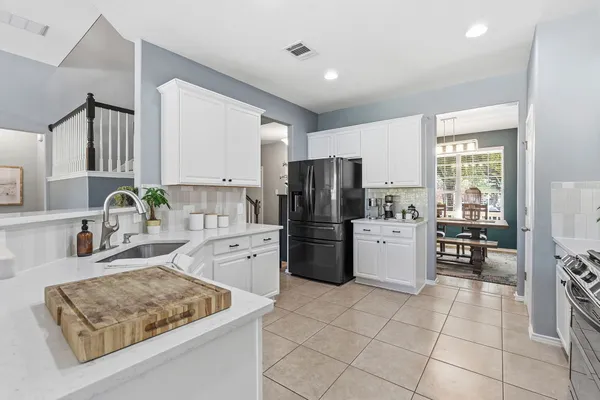 a kitchen with a stove a refrigerator and a sink