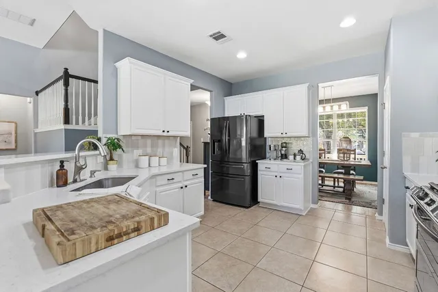 a kitchen with a stove a refrigerator and a sink