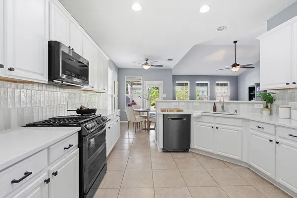 a kitchen with stainless steel appliances granite countertop a sink and stove top oven