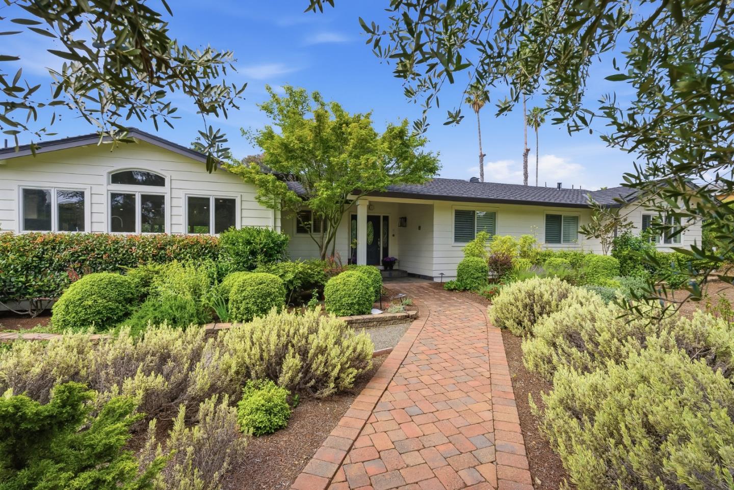 285 Ridgeway Road Woodside, CA 94062 - Photo 3 of 28 a front view of a house with a yard and potted plants