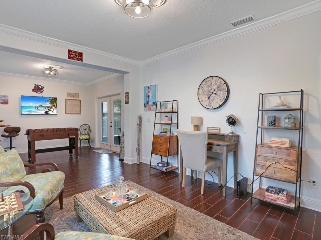 783 92nd Avenue North Naples, FL 34108 - Photo 17 of 32 a living room with furniture a rug and wall clock