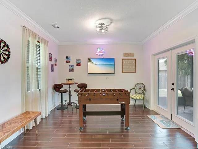 a bedroom with furniture and wooden floor