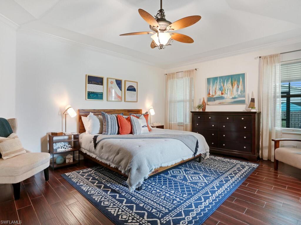 783 92nd Avenue North Naples, FL 34108 - Photo 21 of 32 a bedroom with a bed and wooden floor