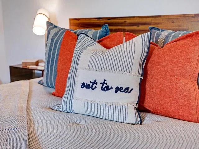 a bedroom with furniture and a flat screen tv