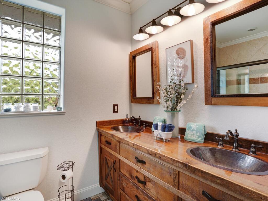 783 92nd Avenue North Naples, FL 34108 - Photo 24 of 32 a bathroom with a toilet sink and mirror