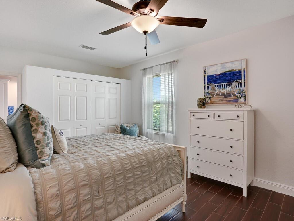 783 92nd Avenue North Naples, FL 34108 - Photo 27 of 32 a bedroom with a bed and a dresser