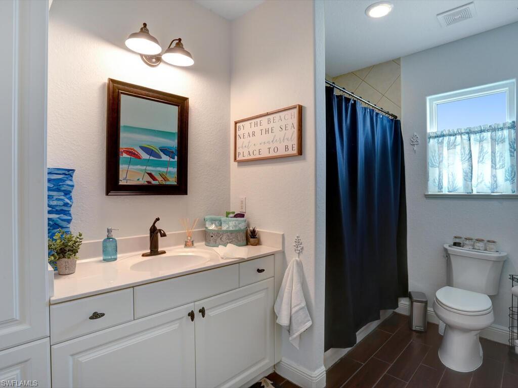 783 92nd Avenue North Naples, FL 34108 - Photo 29 of 32 a bathroom with a toilet sink and mirror