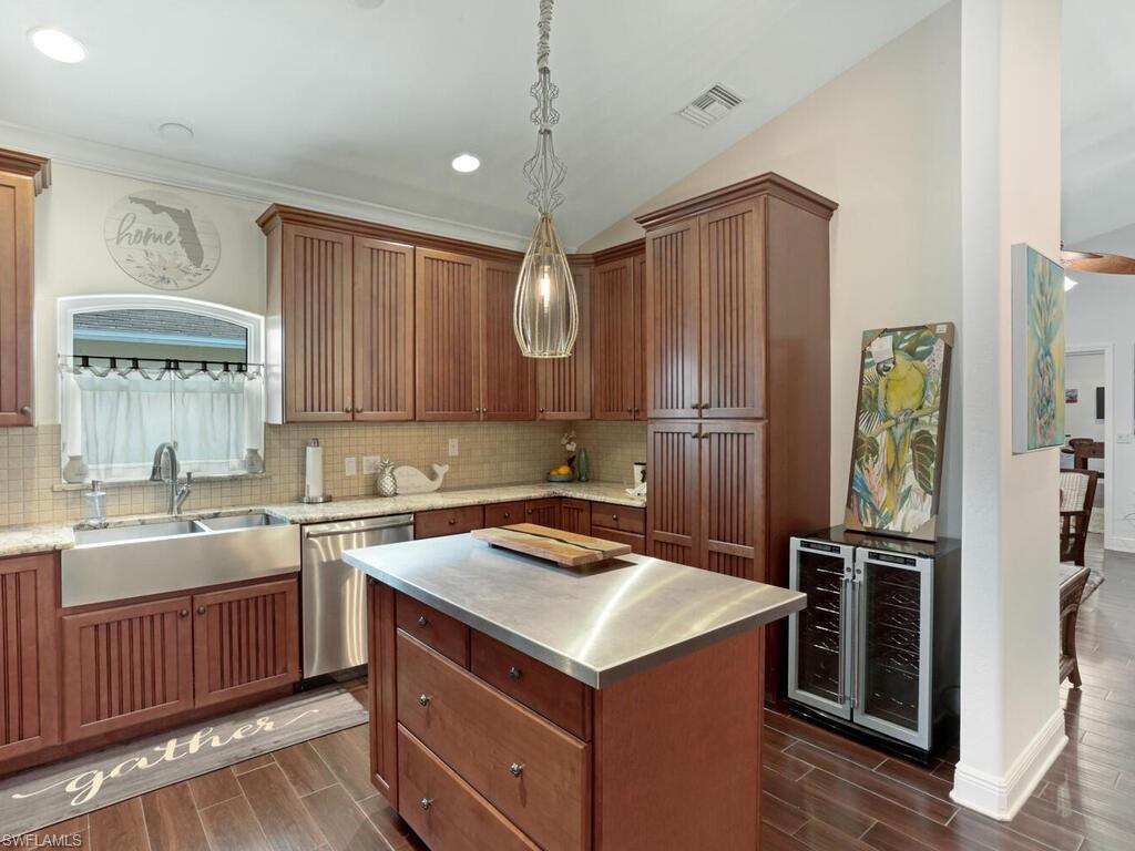 783 92nd Avenue North Naples, FL 34108 - Photo 10 of 32 a kitchen with a sink stove and refrigerator