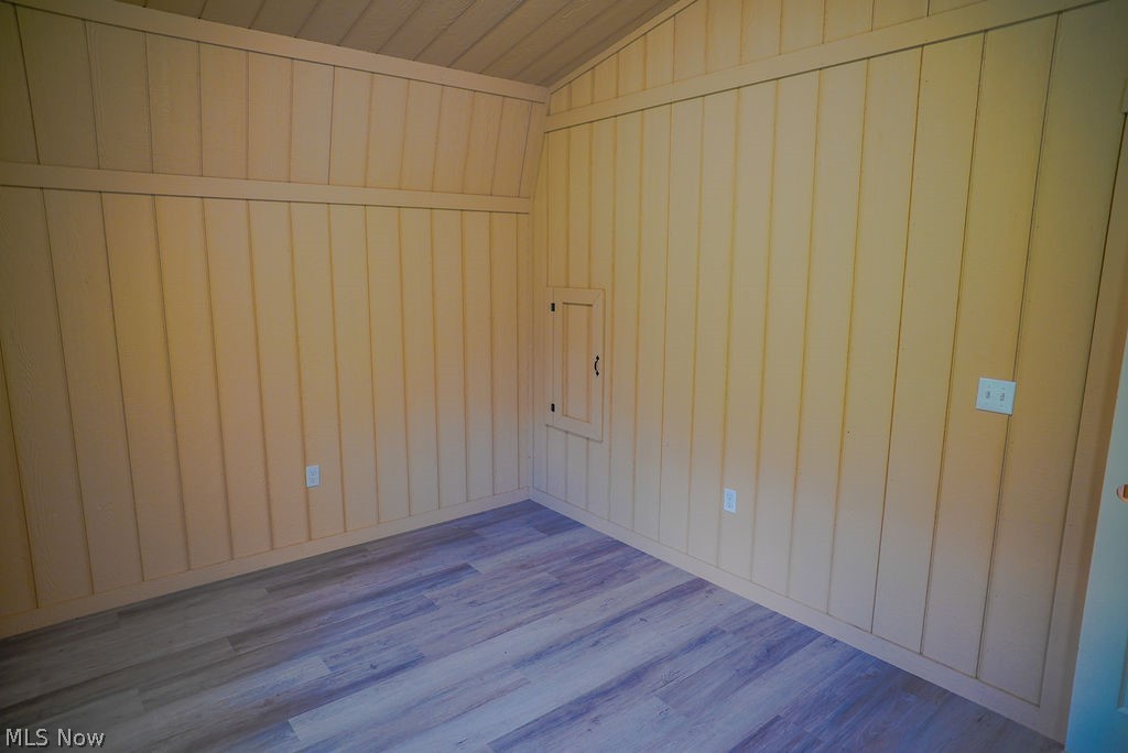 1547 Providence Road Elizabeth, WV 26143 - Photo 16 of 32 Interior space featuring vertical wood-paneled walls and a sloped ceiling with horizontal wood-finish planks