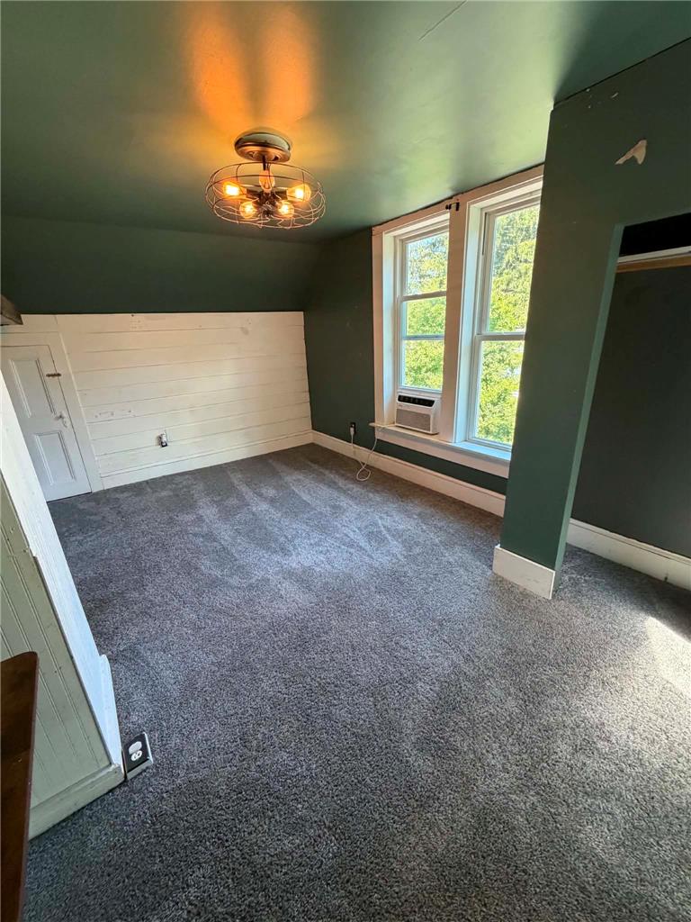 164 Sand Spring Road Cresco, PA 18326 - Photo 41 of 60 A window unit provides cooling in this carpeted bedroom with a charming light fixture.
