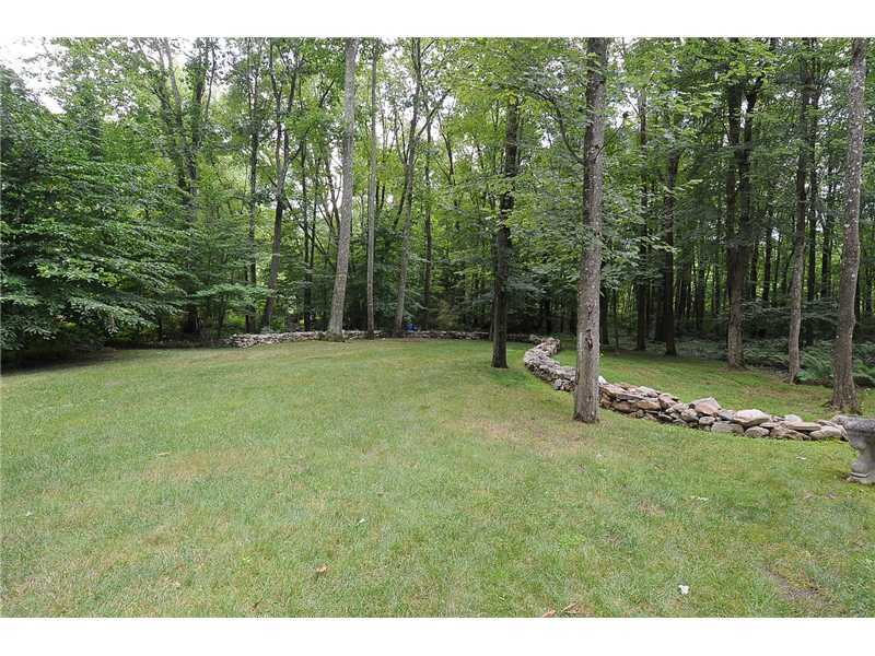 76 Hanson Road Darien, CT 06820 - Photo 25 of 25 a backyard of a house with lots of green space and trees
