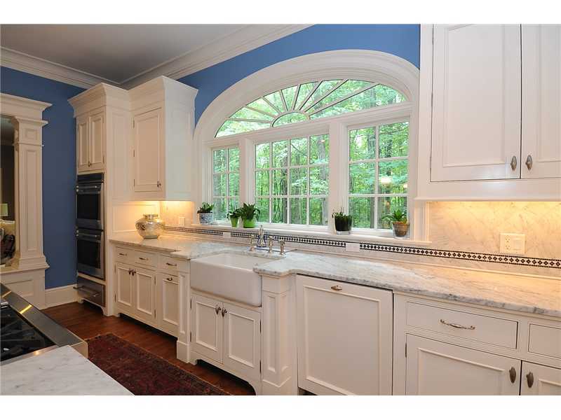 76 Hanson Road Darien, CT 06820 - Photo 6 of 25 a kitchen with stainless steel appliances granite countertop a sink a window and cabinets