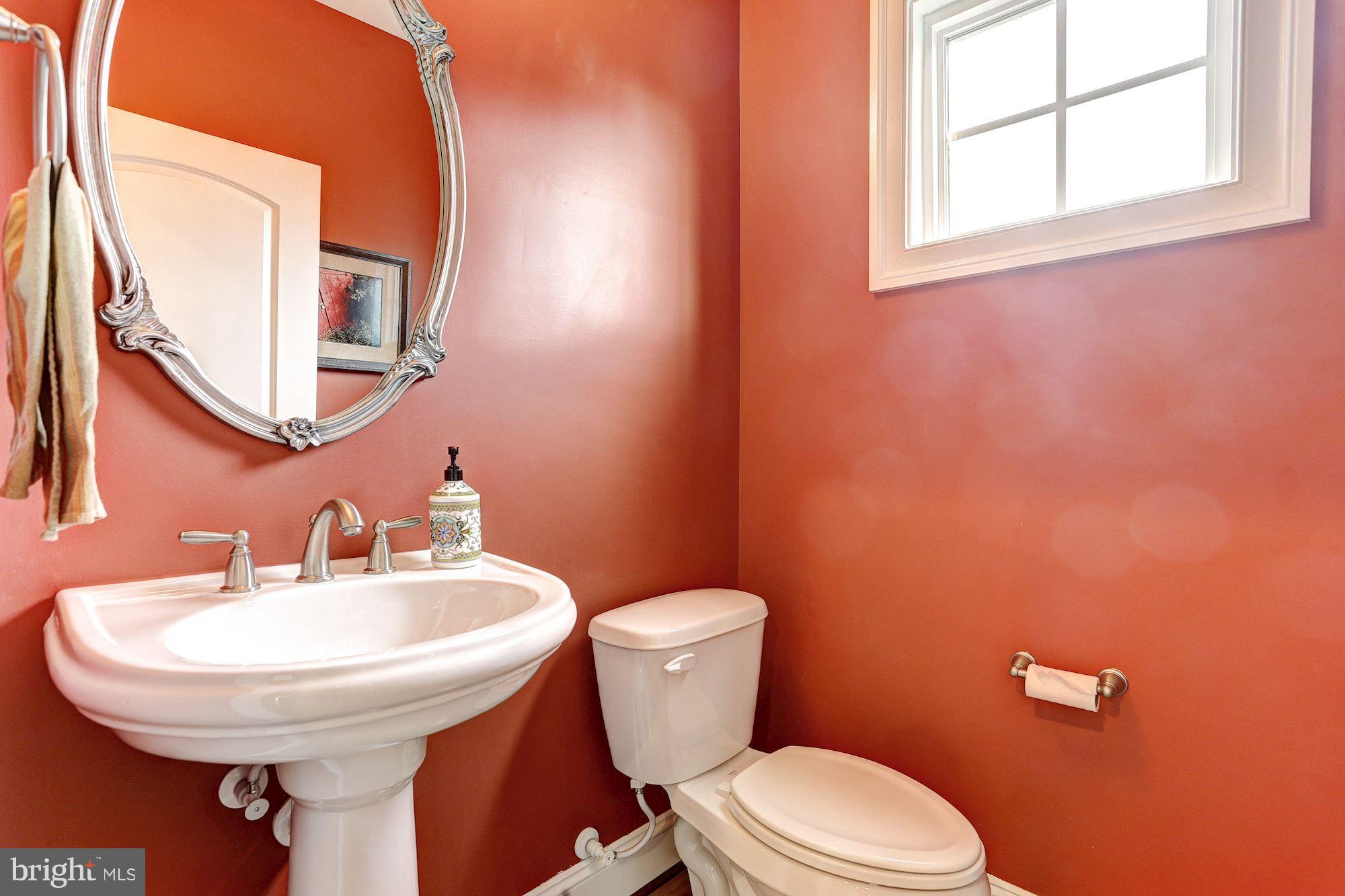7806 Blue Ribbon Street Fulton, MD 20759 - Photo 13 of 30 a bathroom with a sink a mirror and a toilet