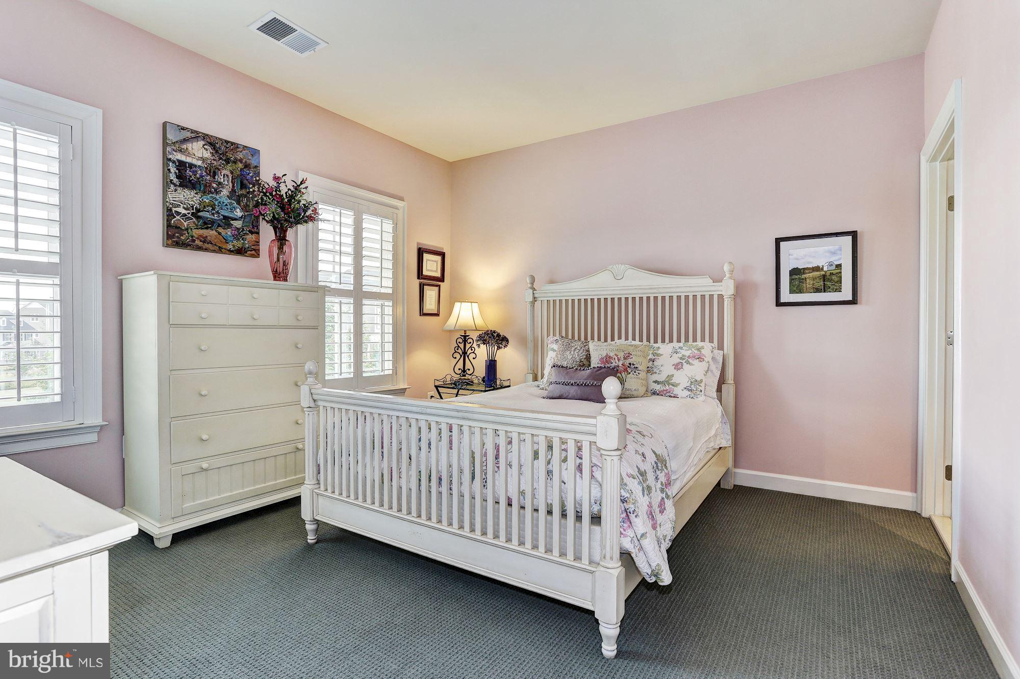 7806 Blue Ribbon Street Fulton, MD 20759 - Photo 16 of 30 a bed sitting in a bedroom next to a window
